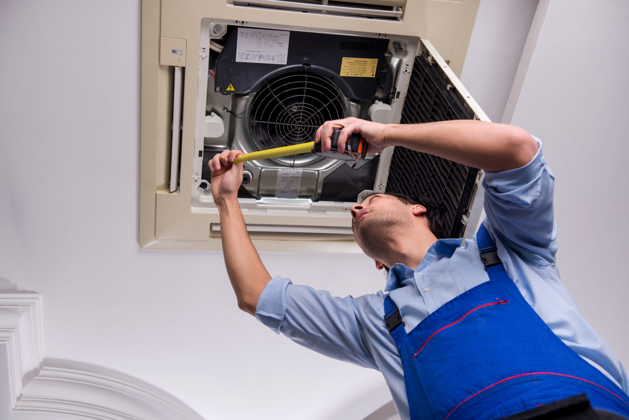 Miami AC Repair Service: Cool Solution Services technician diagnosing an AC unit issue during a repair service in Miami, Florida.